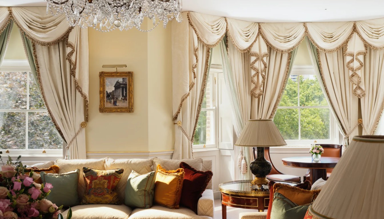 Sunlit suite lounge at The Ritz London with silk drapery, crystal chandelier and views over Green Park