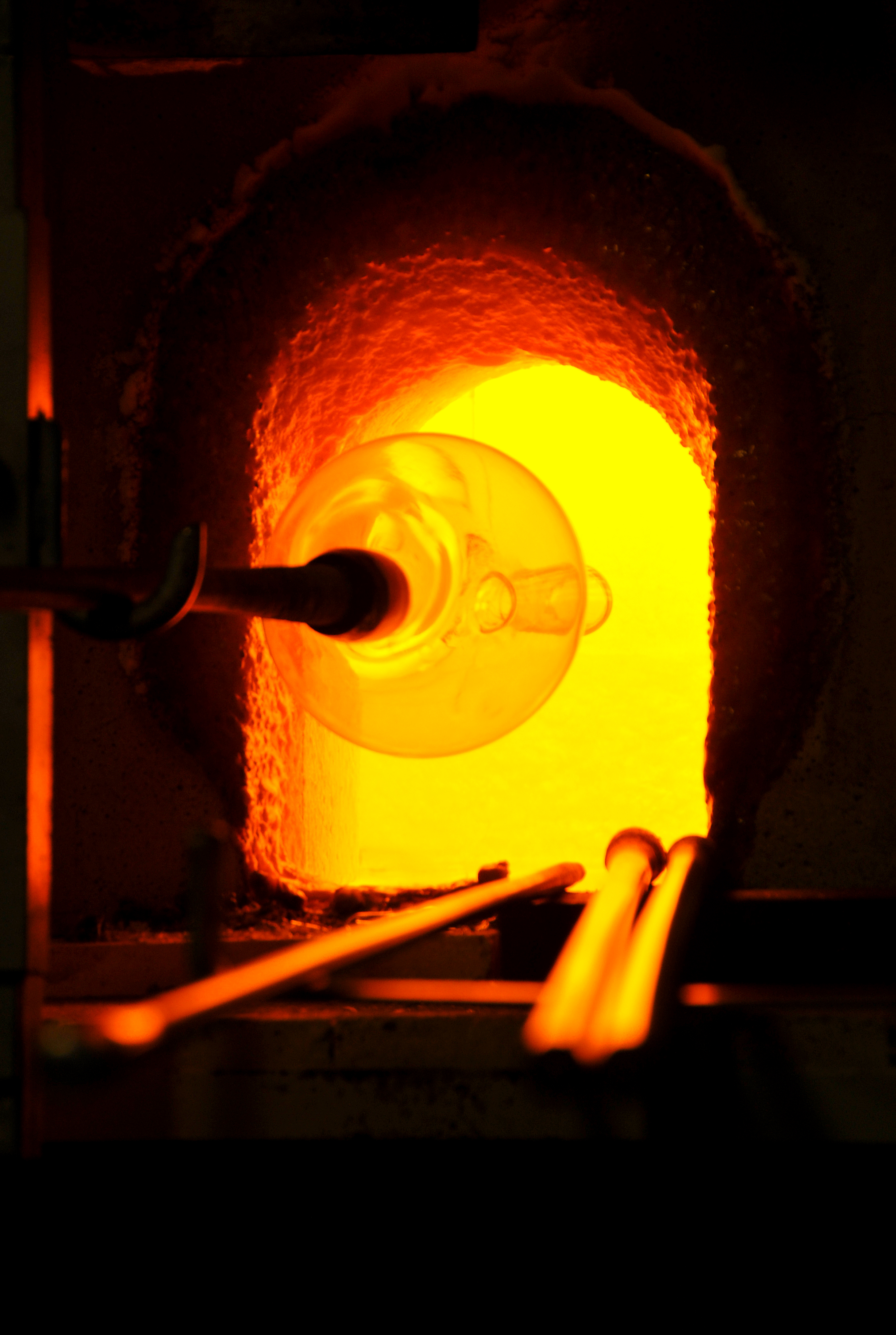Glass artisan working beside a furnace in Murano