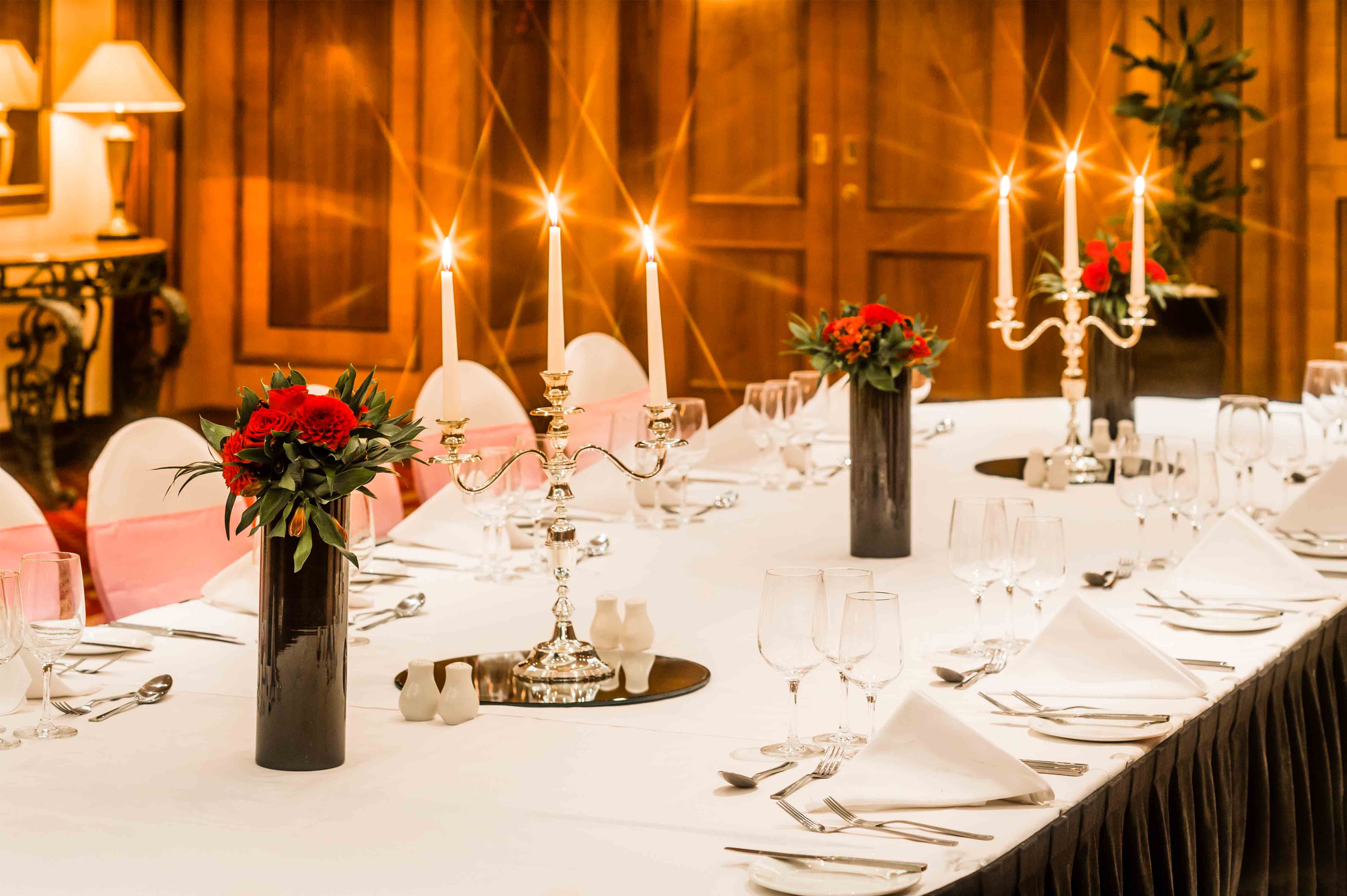 Private dining and meeting room at Copthorne Tara Hotel London Kensington set with a long table, upholstered chairs and formal place settings
