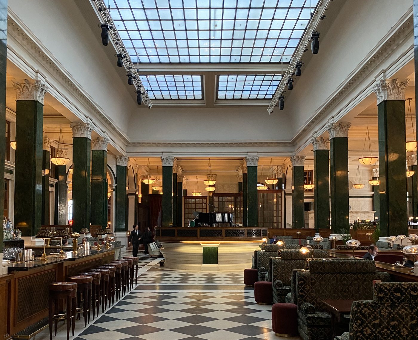 The former Midland Bank banking hall at The Ned London, with green marble columns and restaurant seating