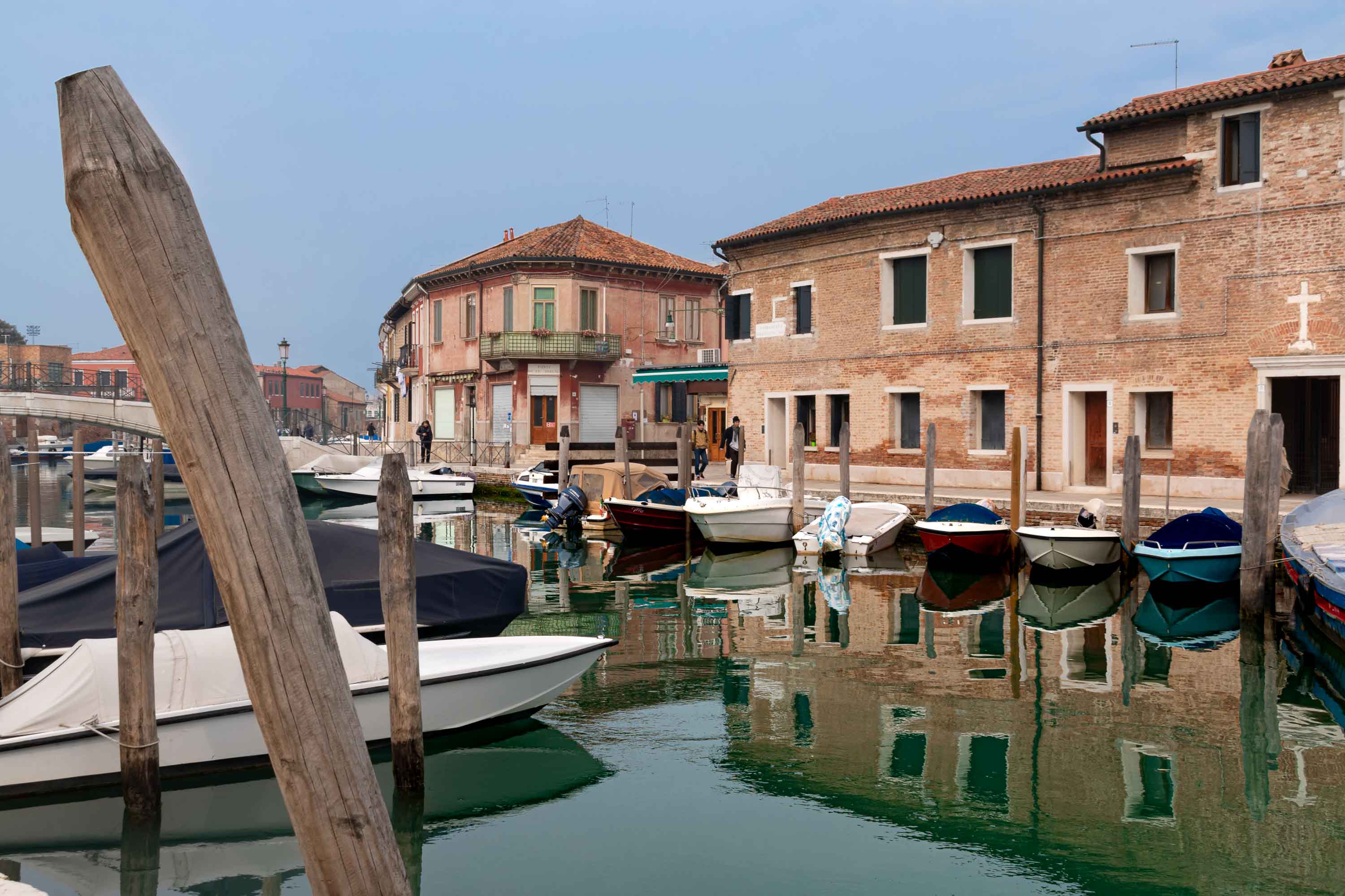 Colourful buildings and boats beside a canal on Murano island