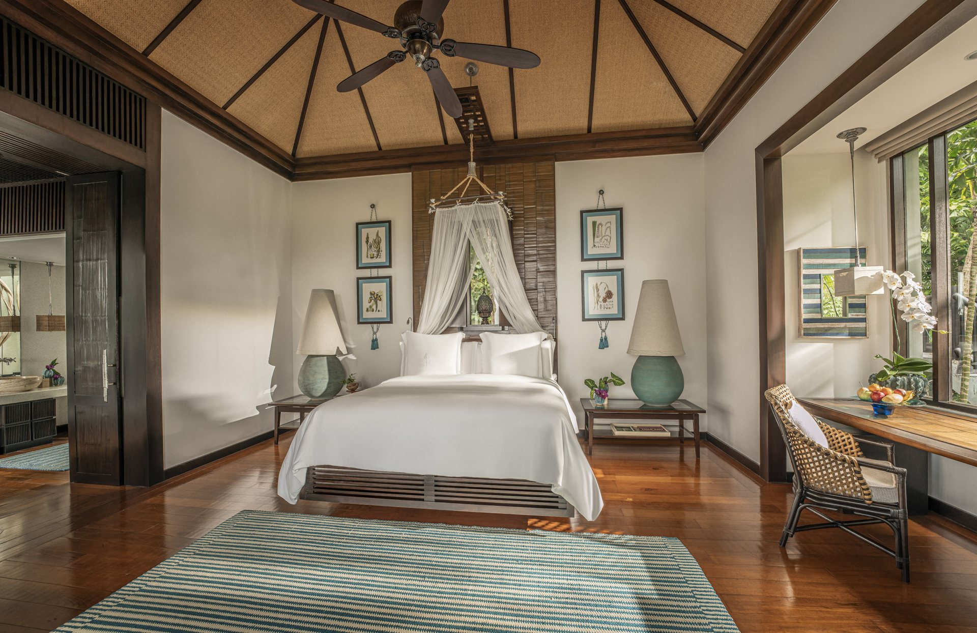 Villa bedroom with canopy bed, timber floors and vaulted ceiling at Four Seasons Resort Koh Samui