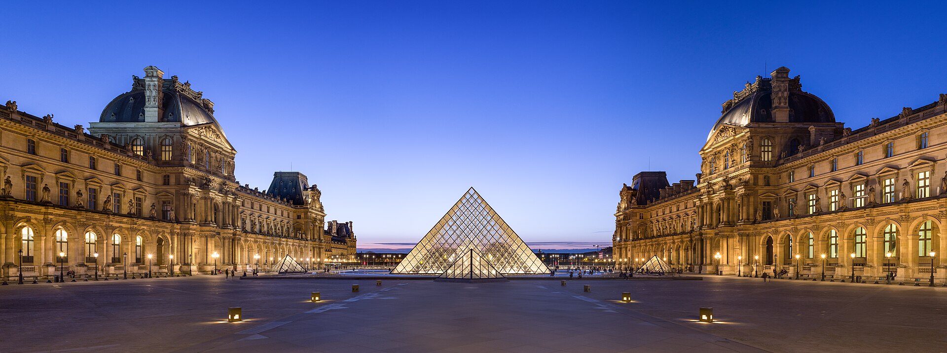 The Louvre Pyramid and Napoleon courtyard at dusk in Paris