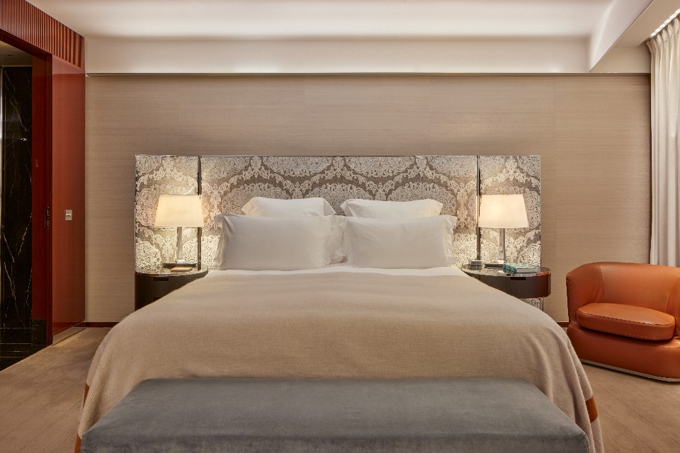 Superior room at Bulgari Hotel London with dark oak panelling, silver detailing and a leather-upholstered bed