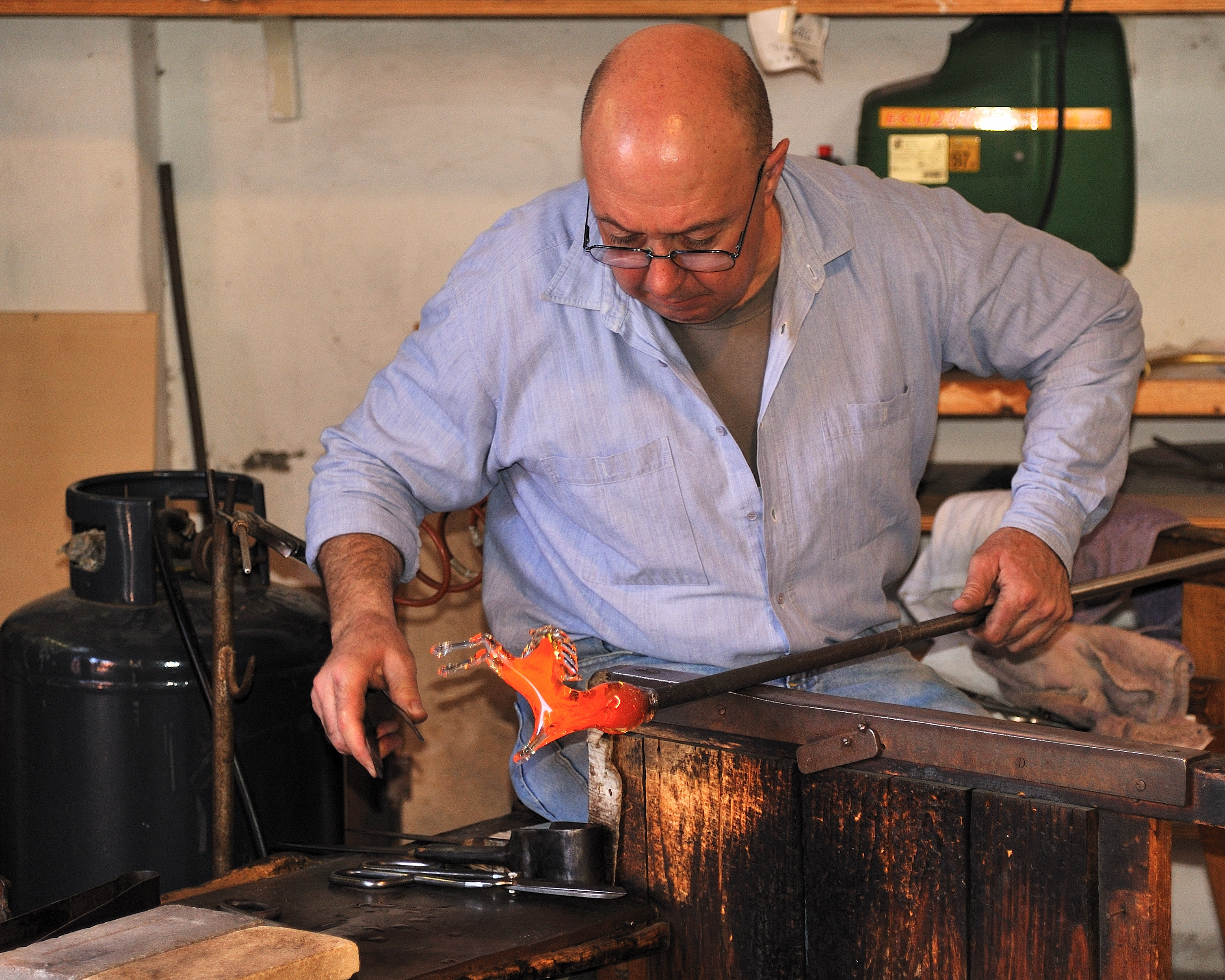 Murano glassmaker sculpting a horse from hot glass