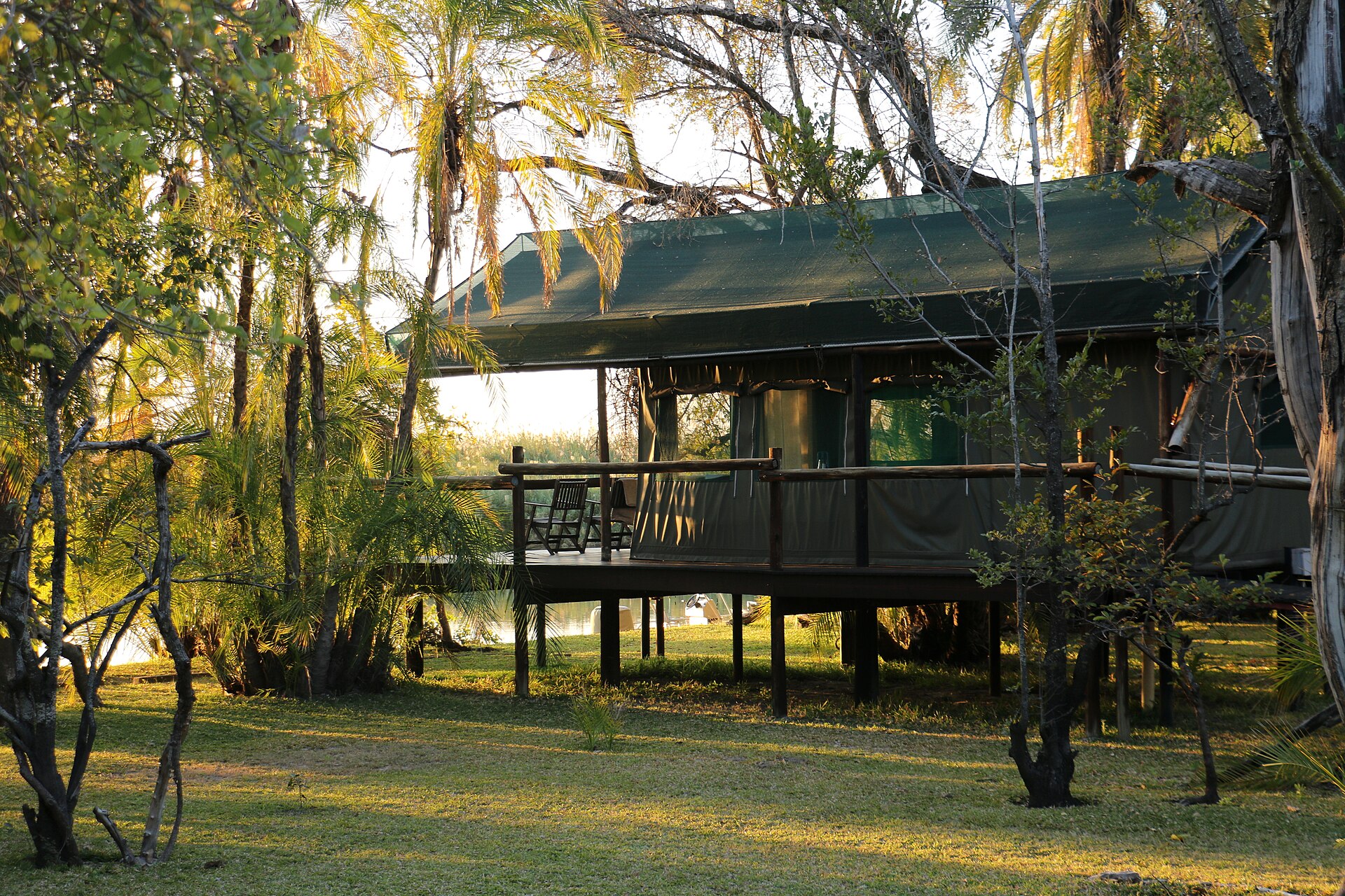 Elevated tented safari suite among riverine trees in the Okavango Delta, Botswana