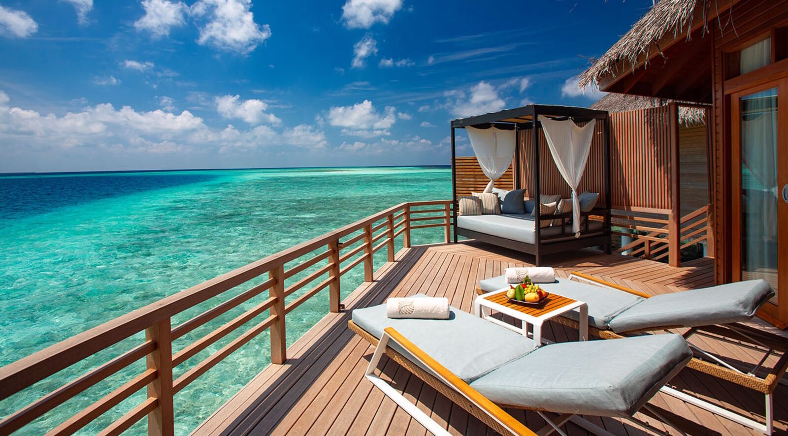 Water villa deck over the lagoon at Baros Maldives
