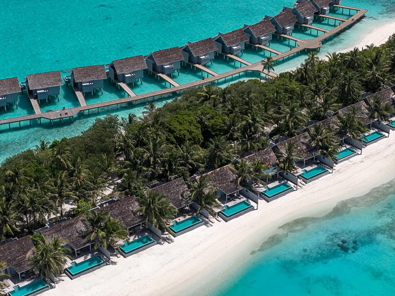 Aerial view of pool villas and reef at Kuramathi Maldives